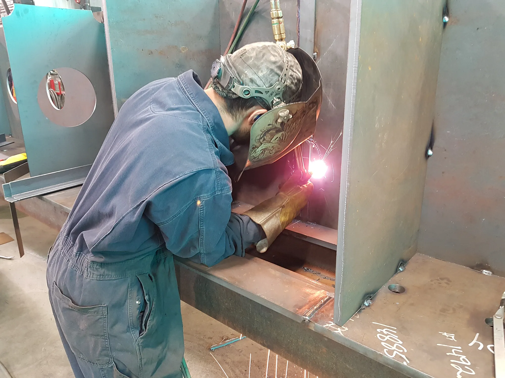 Welder fabricating steel in the Comet Welding shop