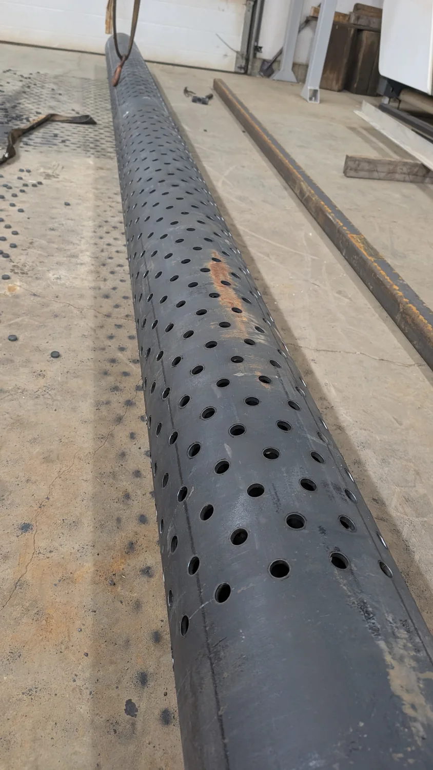 Weld-ready steel tube with holes, slots and copes laser-cut in a single operation